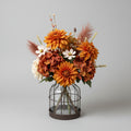 Fall blooms in caged glass vase